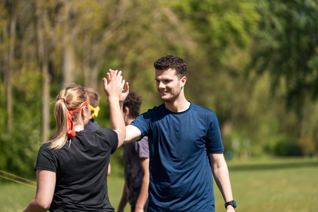 Twee volwassenen die elkaar een high five geven na het sporten
